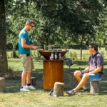 Modern Corten Steel Fire Pit Barbecue Grill with Trolley for Outdoor Use and Firewood Burning