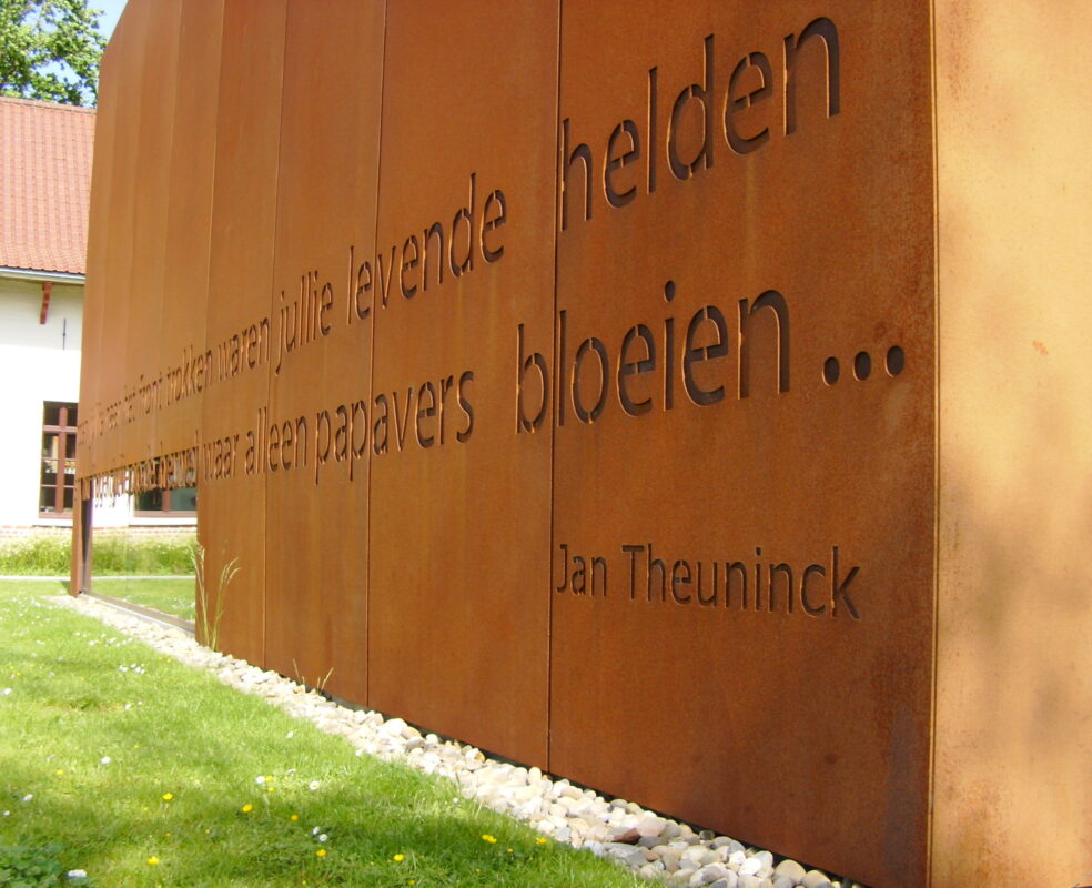 Weathering steel facade with laser-cut lettering on a public building in Zonnebeke, Belgium