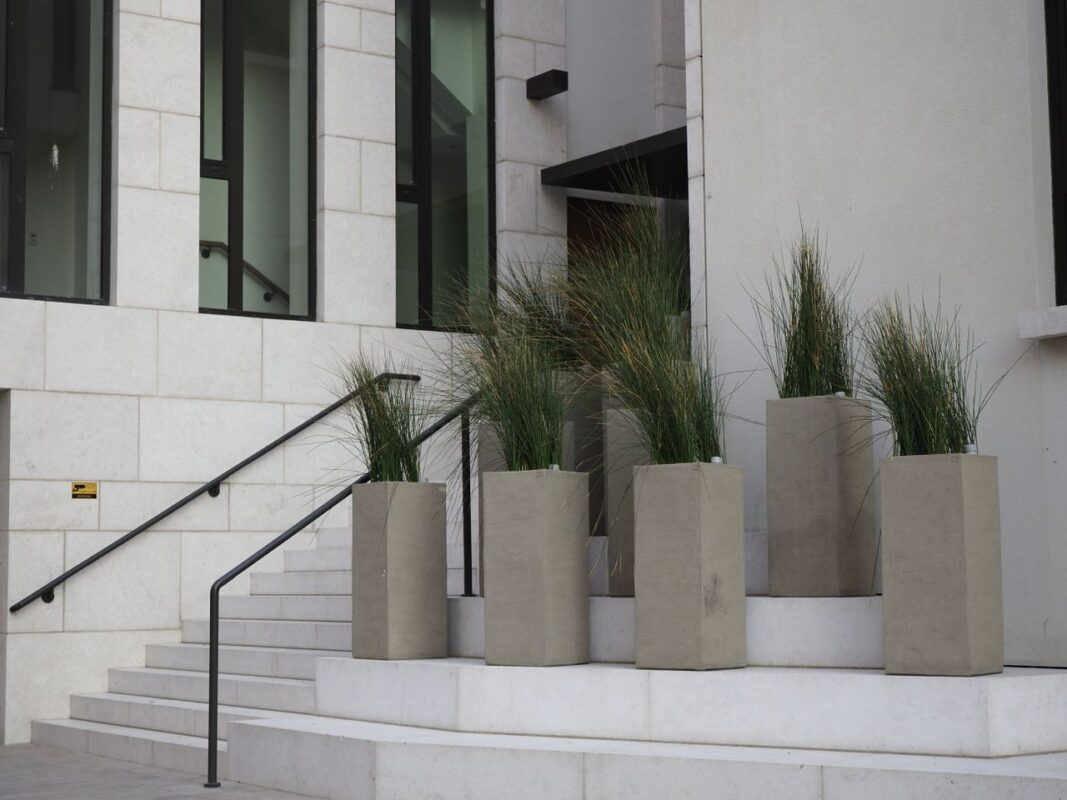 Corten steel planter box with plants in an outdoor landscape