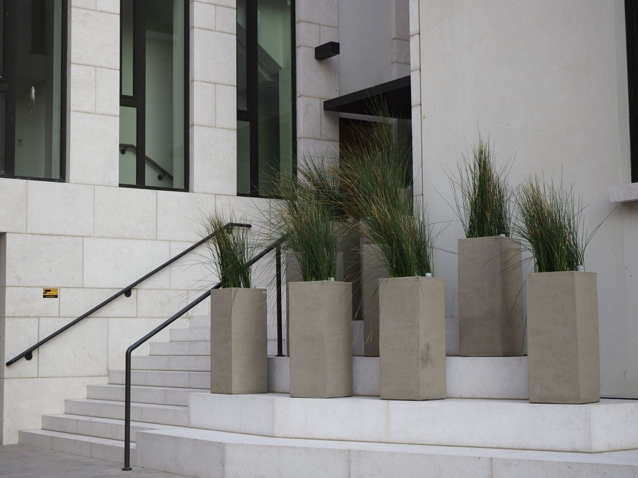 Corten steel planter box with plants in an outdoor landscape