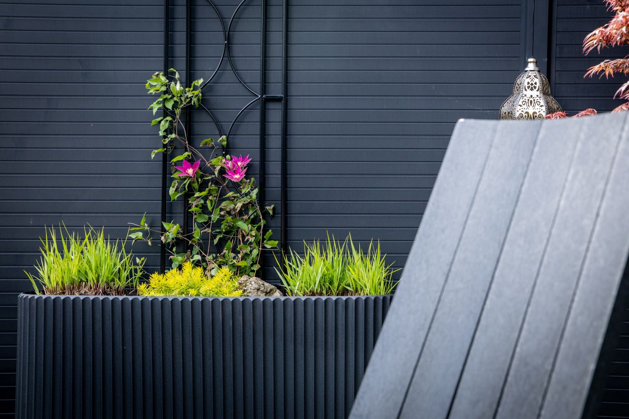 Corten steel planter box with plants in an outdoor landscape