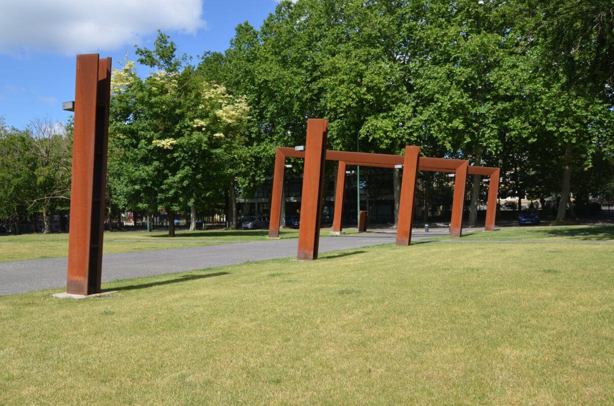 Corten steel landscape screen and sculptural structure with weathered patina in Oman-style setting