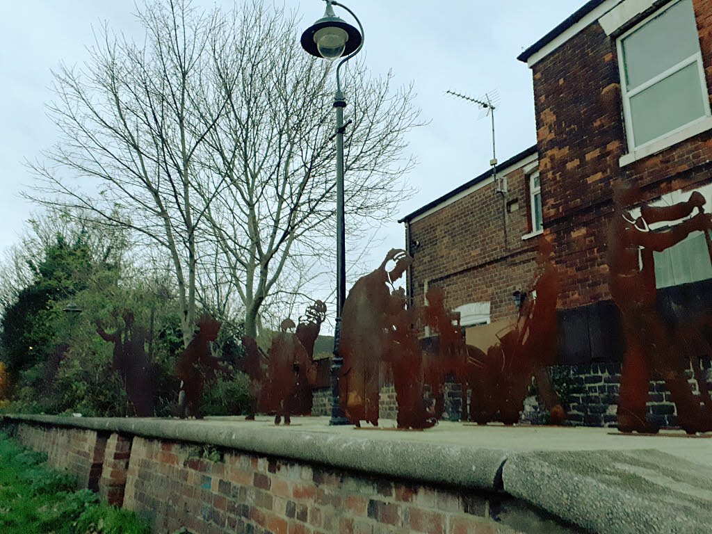 Real corten weathering steel public artwork screen with silhouette panels